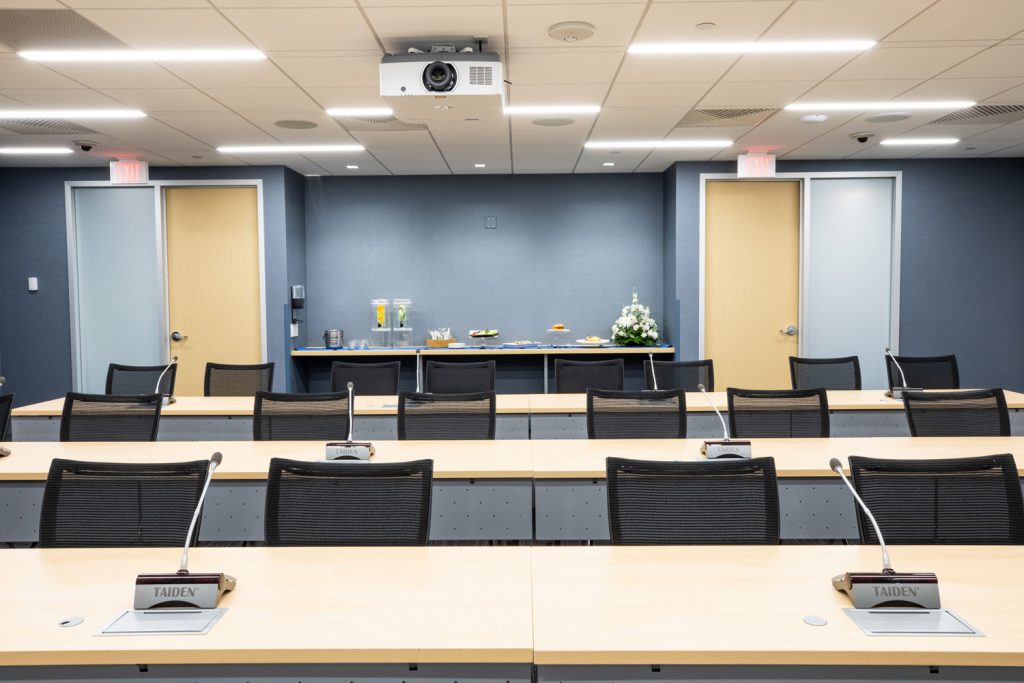 Conference Room 3A at One Rotary Place. Photo of a large conference room with tables & chairs, and catering service food.